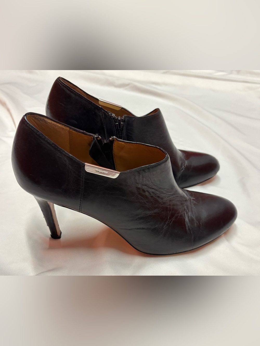 Coach Black Leather Pointed Ankle Booties with Silver Metal Logo Accent